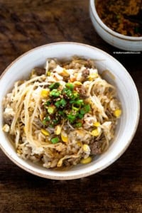 A bowl of soybean sprout rice. Topped with seasoning sauce