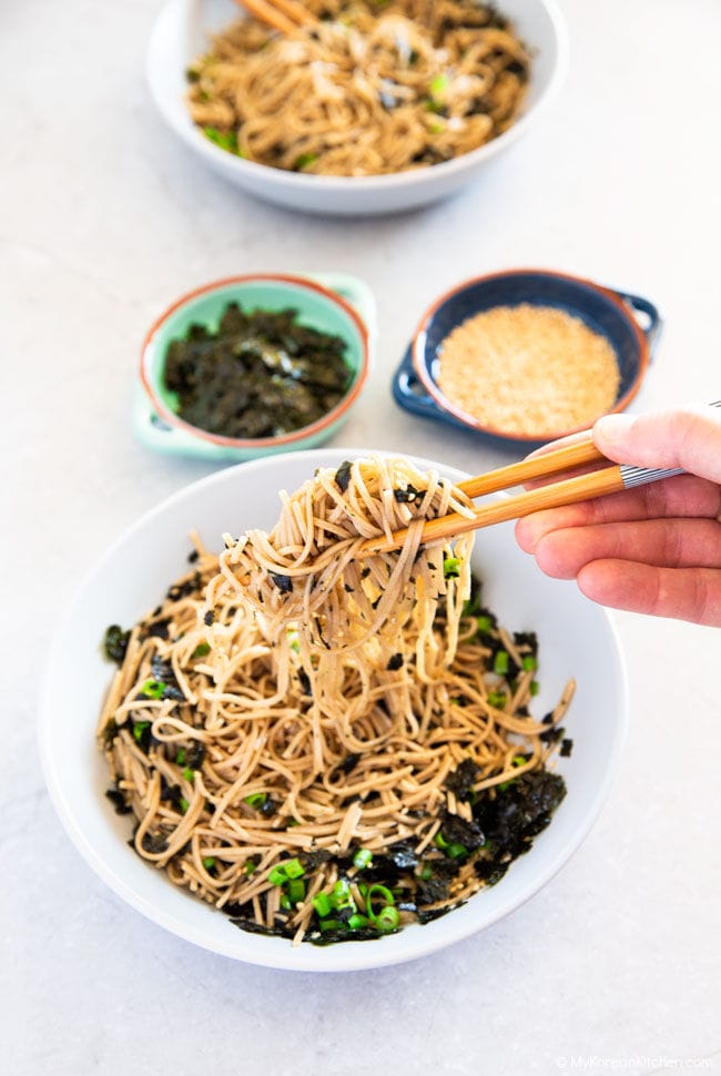 Holding the soba noodles with a chopstick.