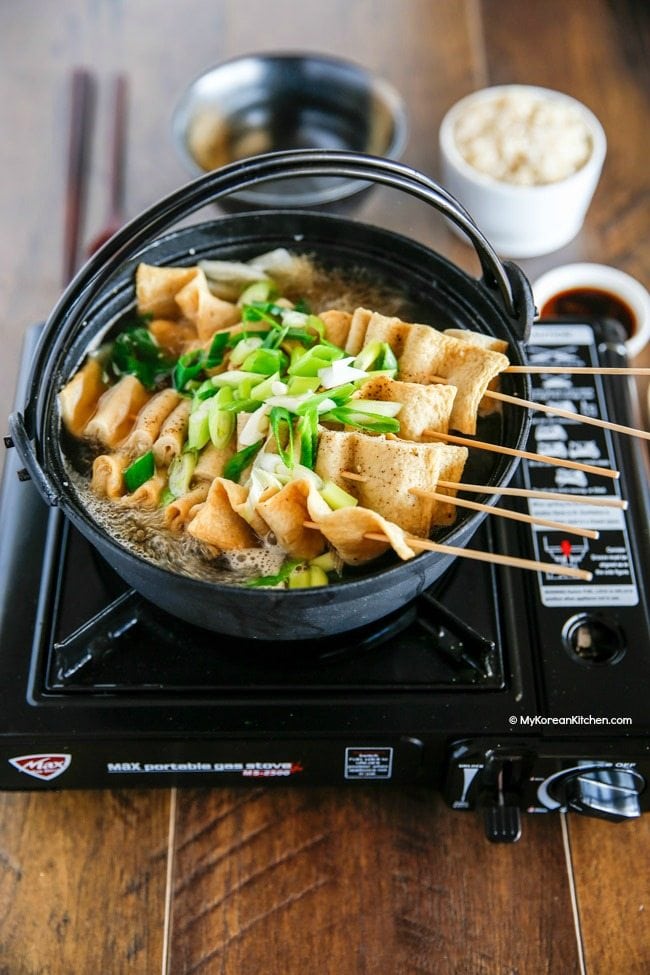 An overhead shot of Korean street food fish cakes in a broth. 