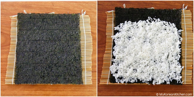 Seasoned rice and dried seaweed on a bamboo mat.