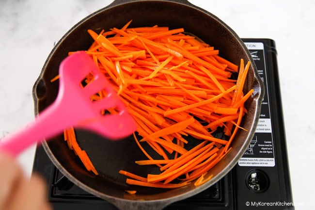 Stir frying julienned carrots