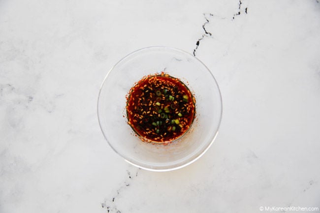 Dotorimuk muchim sauce in a clear bowl.