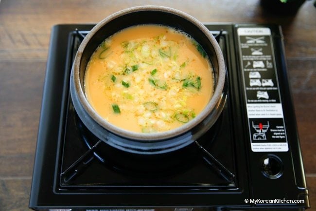 Boiling egg mixture in a Korean hot stone bowl