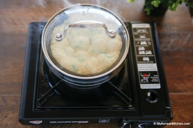 Cooking Korean steamed egg in a Korean hot stone bowl (ttukbaegi)
