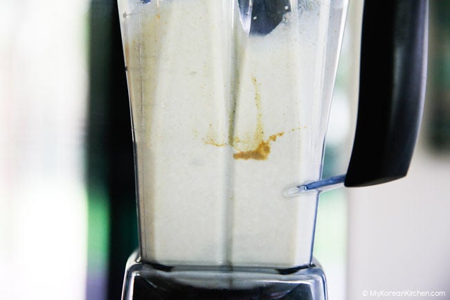 Misugaru latte ingredients being blended in a blender.