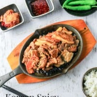 Korean Spicy Marinated Pork (Jeyuk Bokkeum) served on a BBQ grill plate with ssam ingredients.