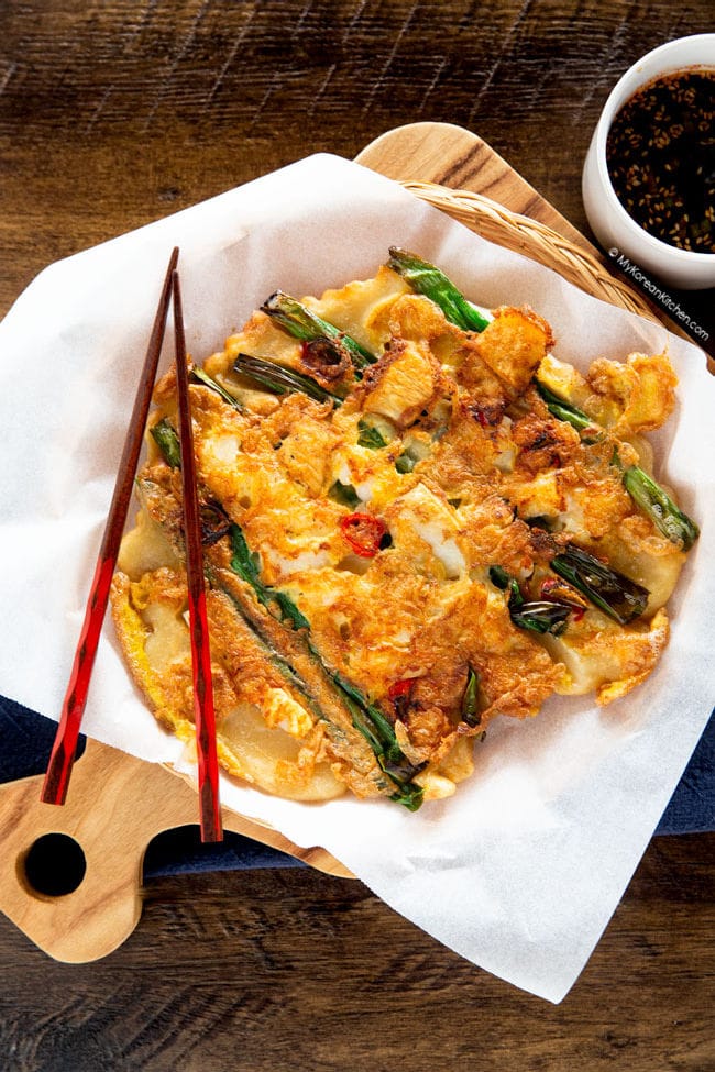 crispy golden brown pajeon served on a wooden cutting board