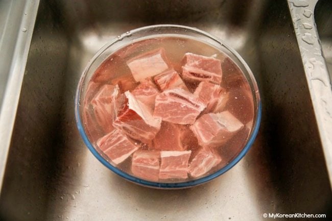 Soak beef short ribs in water