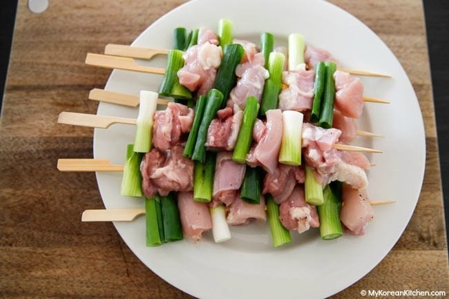 Chicken and green onions on a stick