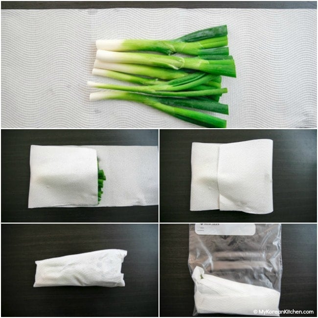Wrapping green onions with some kitchen paper