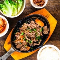 Bulgogi served with rice, lettuce, kimchi and dipping sauce