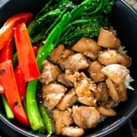 Chicken, broccolini, red bell peppers in a bowl