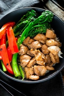 Chicken, broccolini, red bell peppers in a bowl