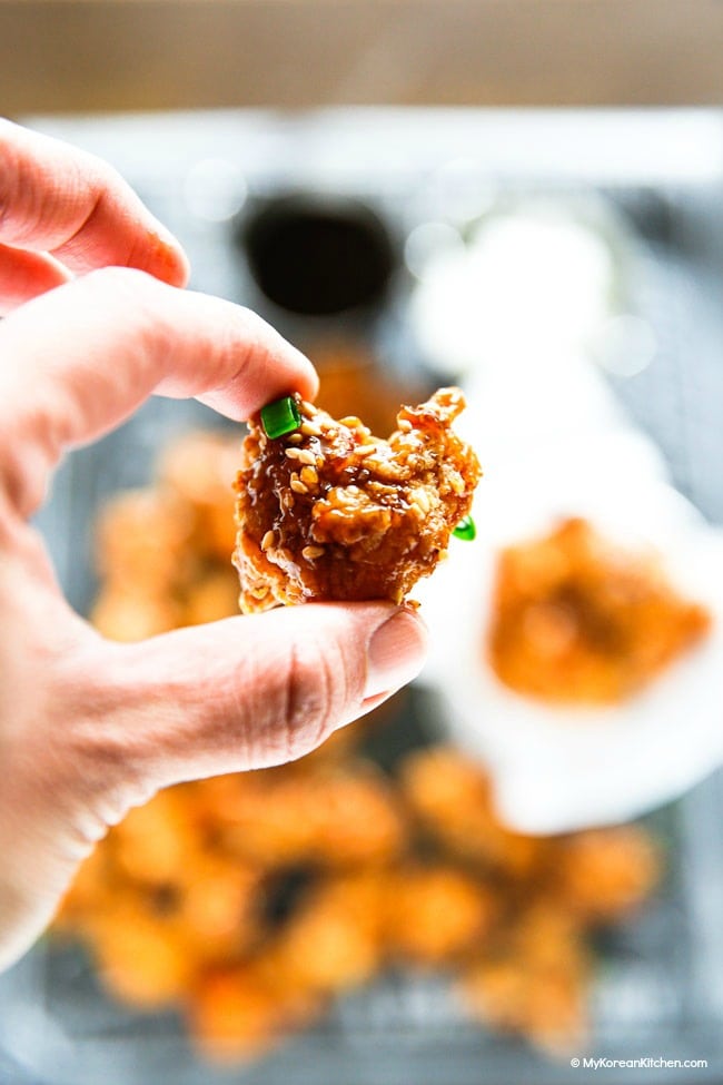 Holding Soy Garlic Popcorn Chicken With Fingers