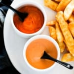 close up photo of spicy gochujang mayo and spicy sriracha mayo served with chips