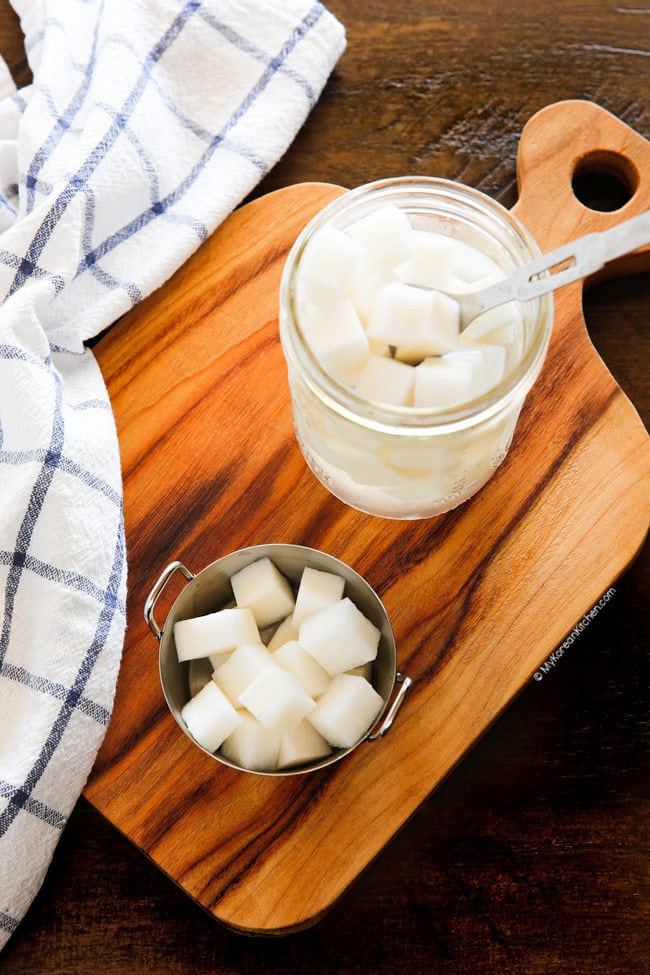 Pickled radishes in a jar and a small bowl