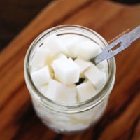 Pickled radishes in a jar with a spoon