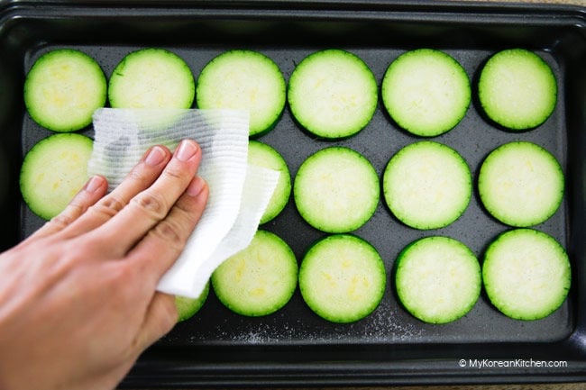 Wiping excess water from sliced zucchini