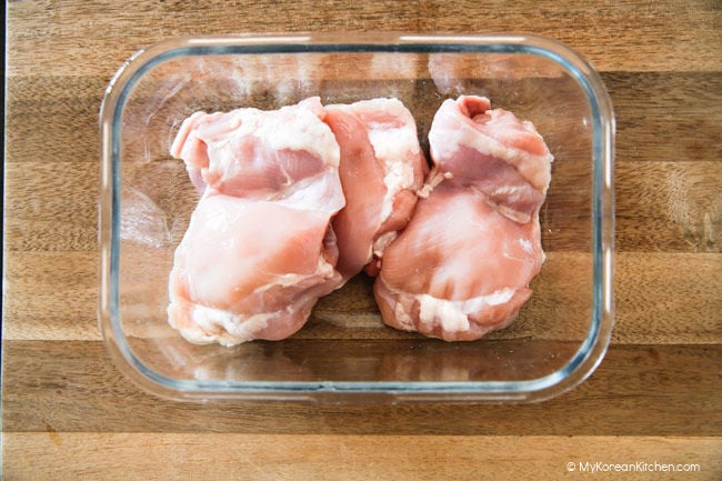 chicken thighs in glass container