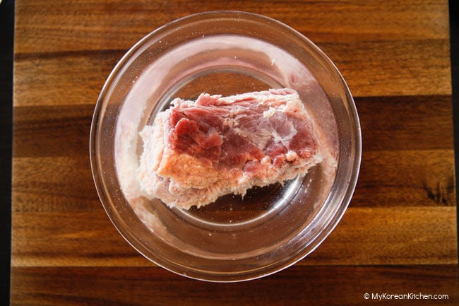 Soaking brisket in a bowl of water