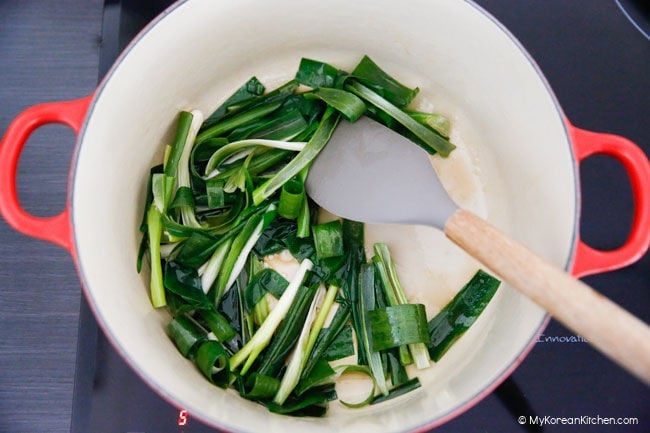 Stir frying green onions in a pot