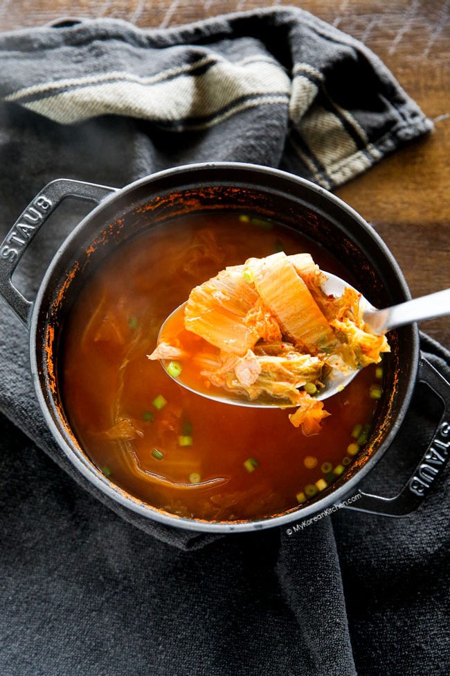 Kimchi soup scooped out on a ladle