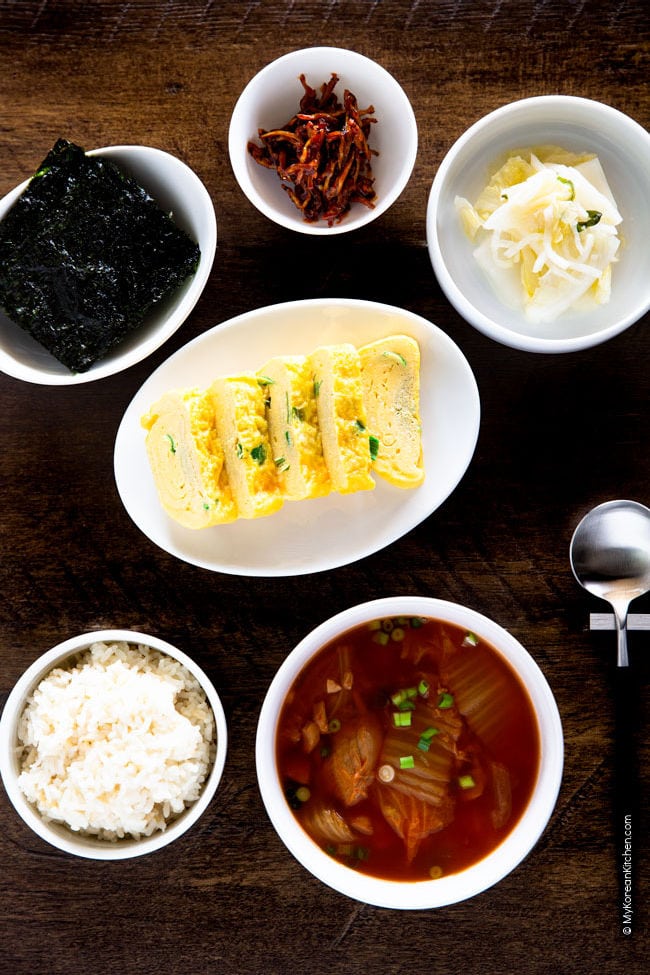 Kimchi soup served with various Korean side dishes and rice