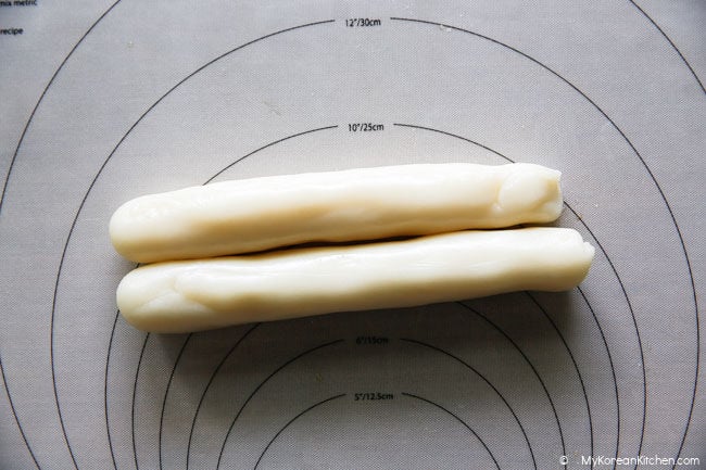 Two long garaetteok rice cakes shaped into cylinders
