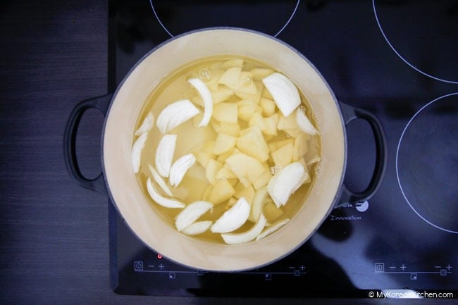 Boiling Korean soup stock with potatoes and onions
