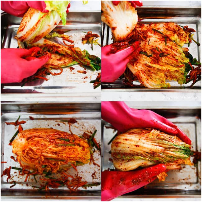 Putting kimchi seasoning on cabbage