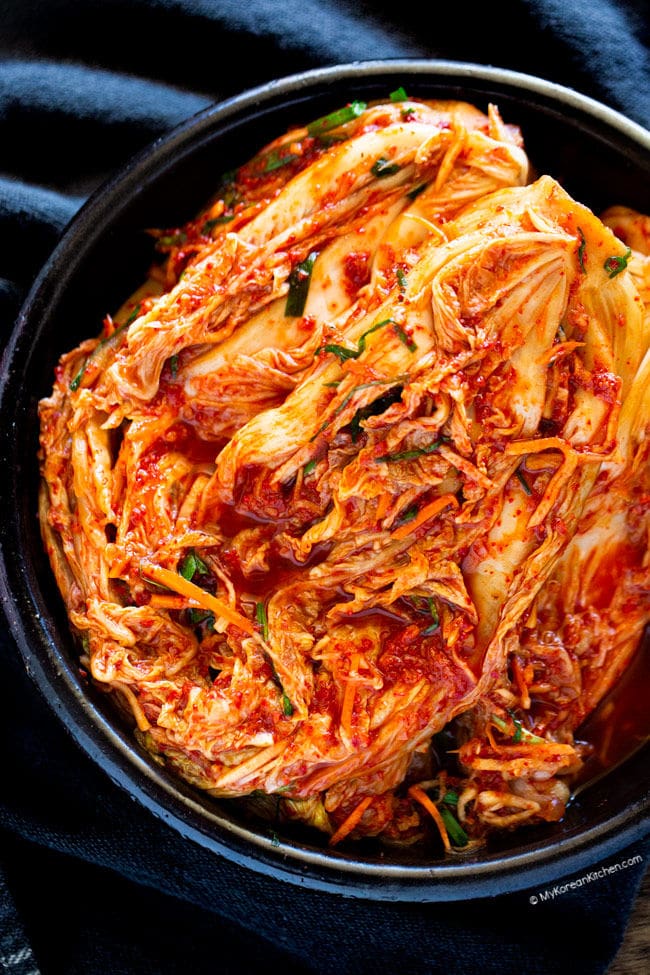 Top down shot of kimchi in a large black bowl