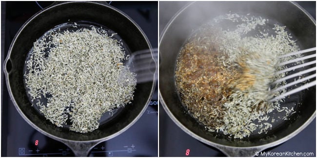 Stir-frying dried anchovies in a skillet.
