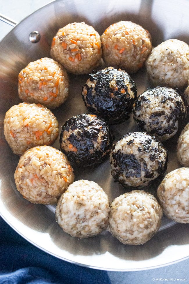 Rice balls served on a stainless steel plate.