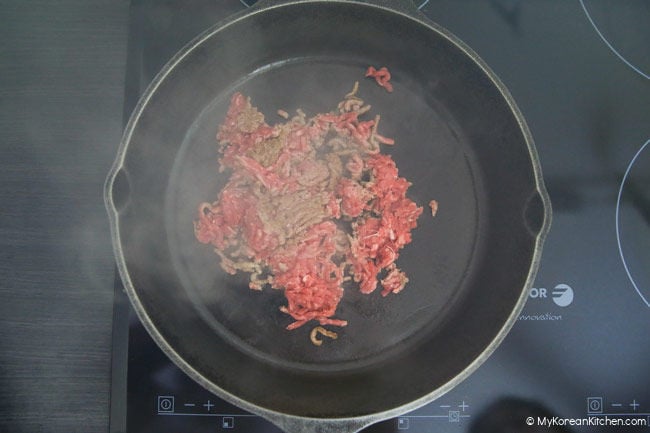 Stir frying minced beef in a skillet