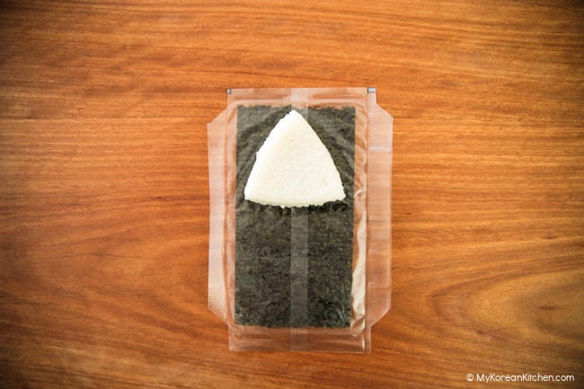 Triangle rice laying on dried seaweed