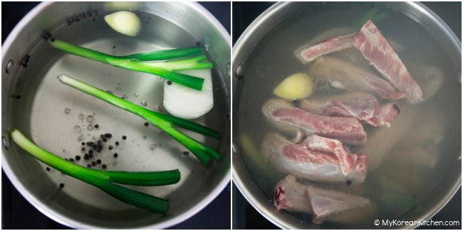 Boiling pork ribs with green onion, garlic, onions, and black peppers in a large pot.