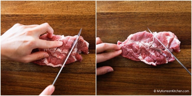 Tenderizing pork by giving gentle cuts on a wooden cutting board.