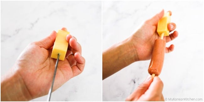 Skewering a block of cheese on a stick.