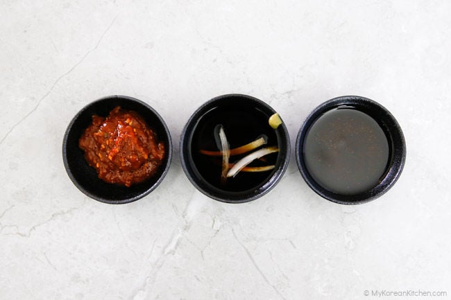 Three Korean BBQ dipping sauces: spicy, wasabi soy, and sesame oil.