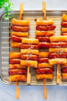Sotteok skewers placed neatly on a stainless steel plate.