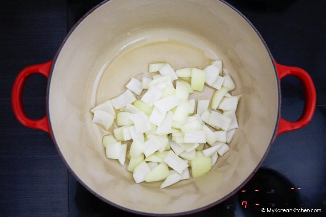 Stir frying onions in a large pot.
