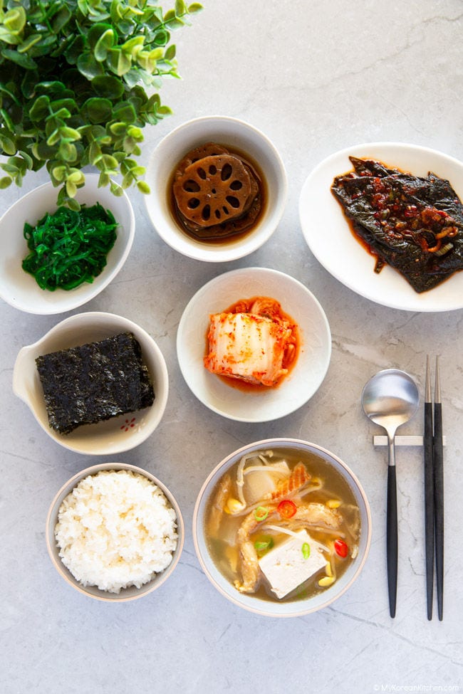 Dried pollack soup served with various Korean side dishes and rice.