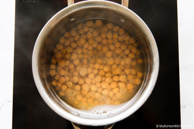 Boiled chickpeas in a small pot.