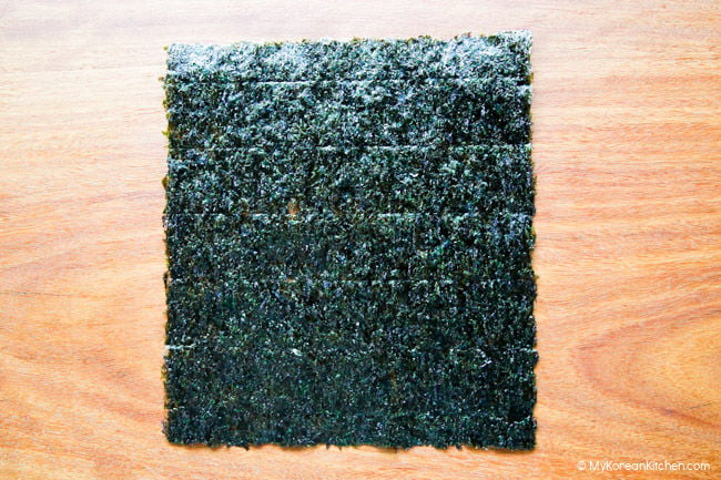 Dried seaweed placed on a wooden cutting board.