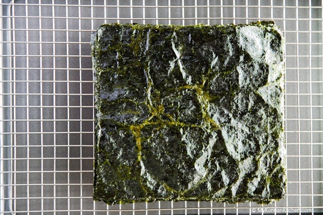 Cooling roasted seaweed on a wire baking rack.