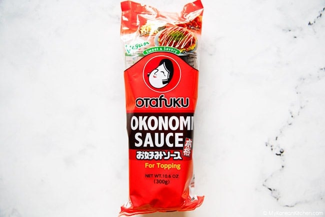 Okonomi sauce bottle on a white countertop.