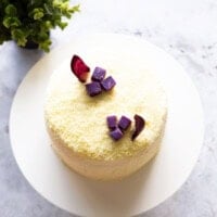 Top-down shot of a Korean sweet potato cake on a white cake stand.