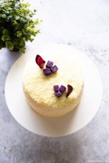 Top-down shot of a Korean sweet potato cake on a white cake stand.