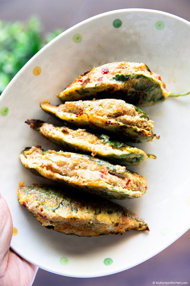 Holding an oval plate with five stuffed perilla leaves neatly lined up