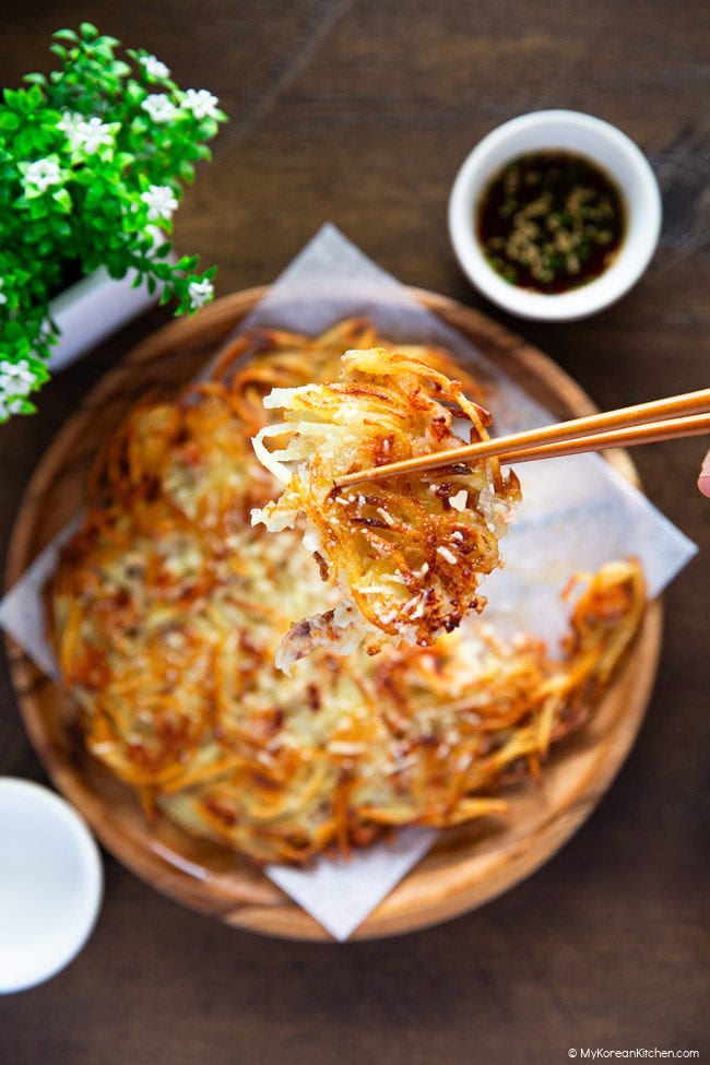 Holding a crispy piece of matchstick potato pancake with chopsticks.